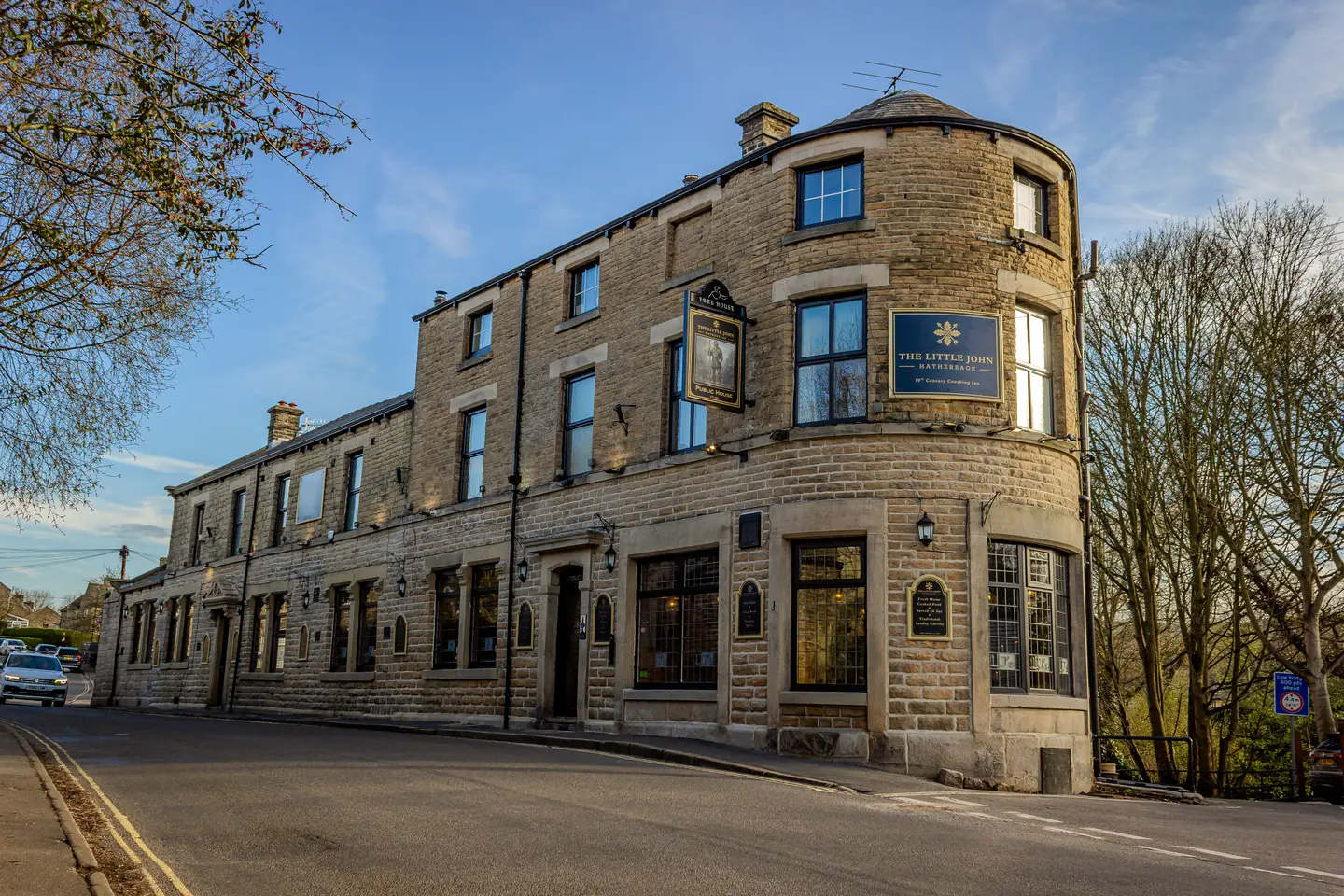 The Little John on the corner of Station Road, Hathersage, under a clear spring sky