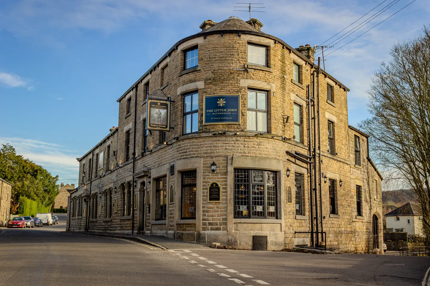The gritstone frontage of The Little John seen along Station Road, Hathersage