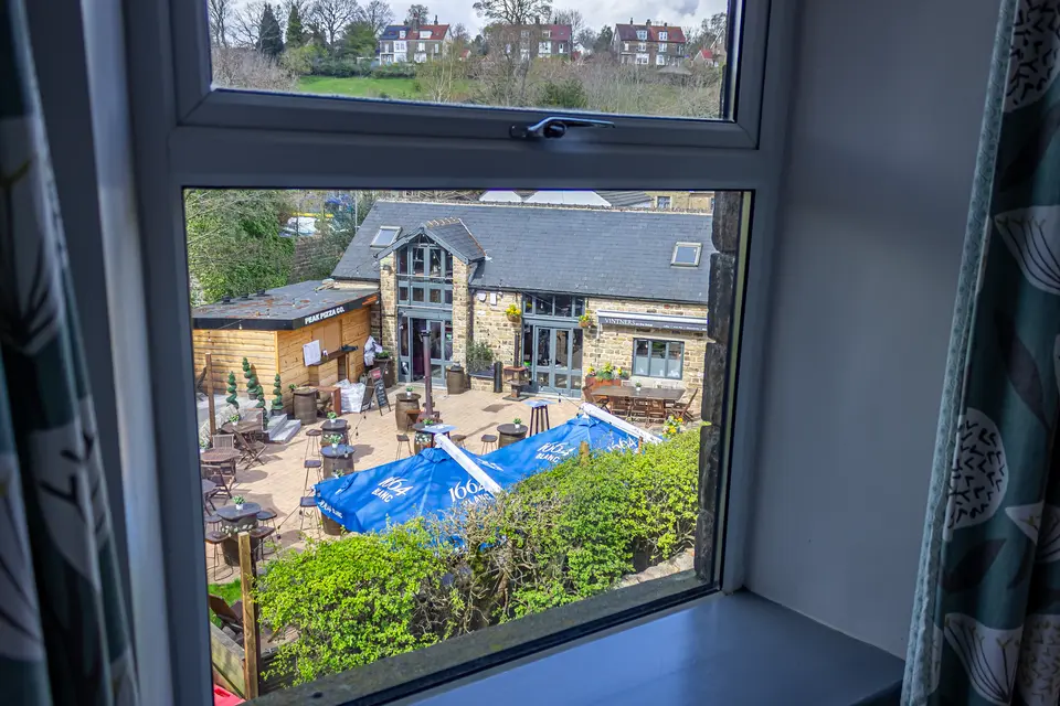 The view from a bedroom window at The Little John, looking down over Vintners on the Brook and Peak Pizza Co in Hathersage
