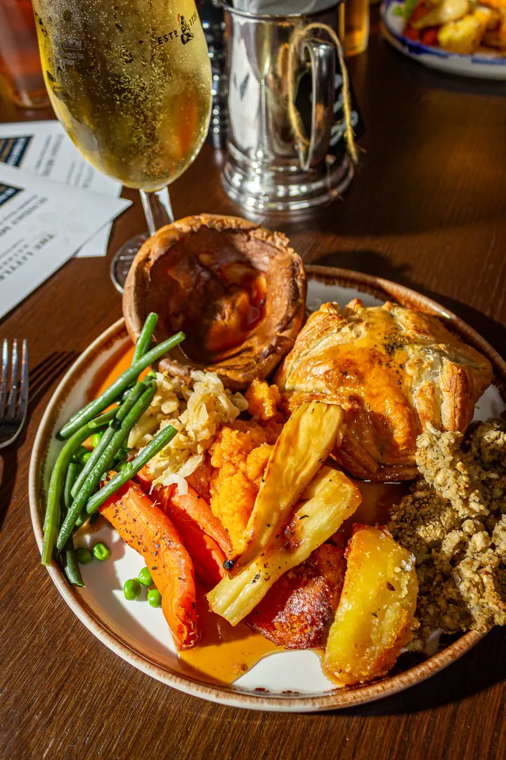A plated Sunday roast with a large Yorkshire pudding